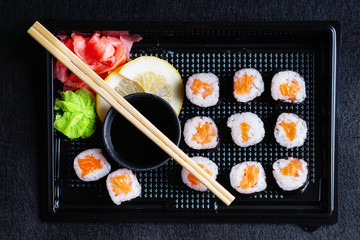 Sushi rolls with salmon, soy sauce and chopsticks 