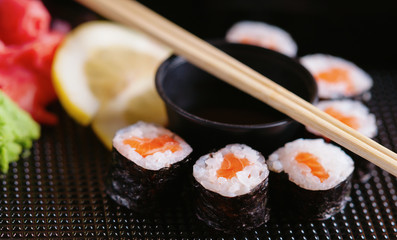 Sushi rolls with salmon, soy sauce and chopsticks 