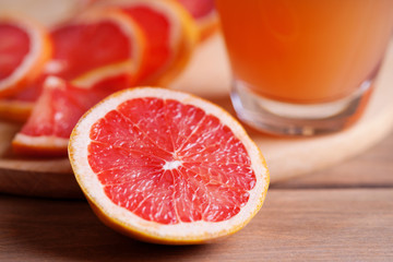 Photography of a grapefruit slice on a wooden table