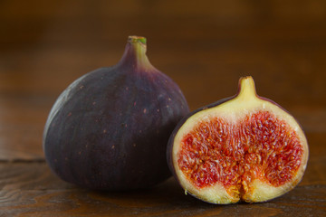 Ripe juicy figs on brown cutting board