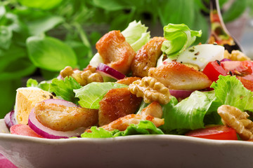 Delicious salad with chicken, nuts, egg and vegetables.