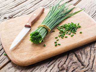 Green onion on the wooden table.