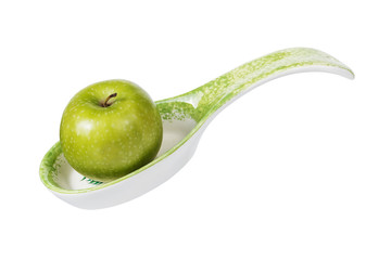 A large green apple in a spoon with a stand
