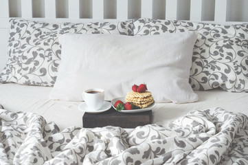 Breakfast in bed coffee, waffles, strawberry