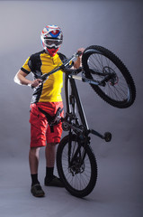 Fototapeta na wymiar Portrait of a professional cyclist wearing a helmet on a gray background.
