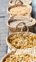 Dry herbs in handmade braided basket for sale on market