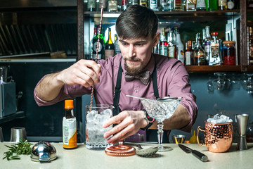 The barman prepares drinks in the club behind the bar