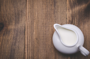 creamer on a wooden background/creamer on a wooden background. Top view