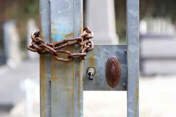 And old rusty iron handle, lock and chain