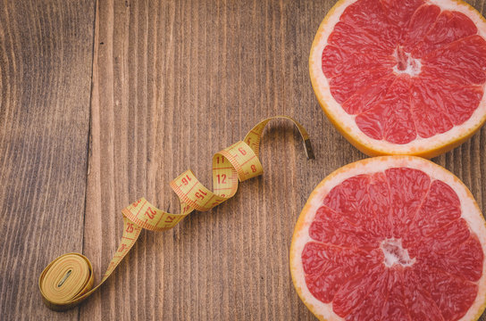fitness concept with centimeter and grapefruit. Top view/fitness background with centimeter and grapefruit