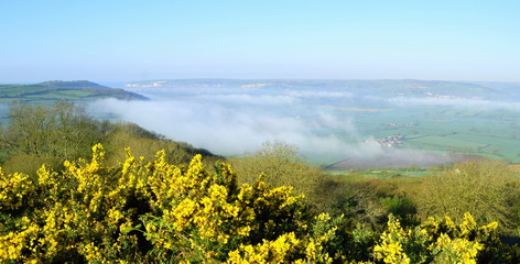Panoramic view over Axe Valley, Devon on a foggy spring morning