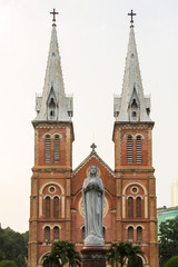 Fototapeta na wymiar Maria statue in Notre Dame cathedral with white sky background, Ho Chi Minh City, southern Vietnam