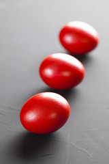 Red easter eggs on plastered background