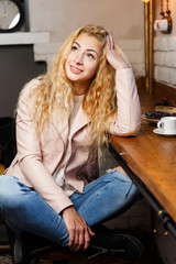 Young long-haired blonde in cafe