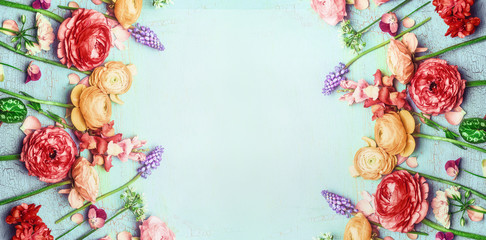 Pretty floral banner with various colorful garden flowers on blue turquoise shabby chic background, top view