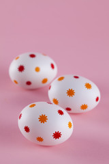 Three easter eggs on pink background