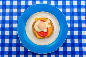 poached egg on tomato, cheese and brown bread