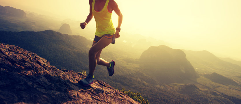 Young Fitness Woman Trail Runner Running At Mountain Top