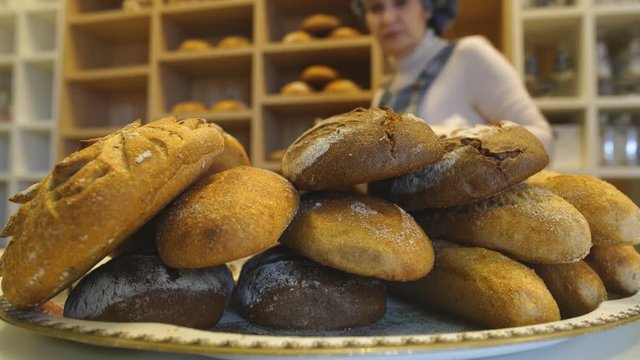 handmade bread loaves on the counter top of a modern bakery
