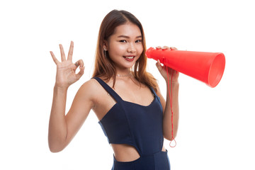 Beautiful young Asian woman show OK  announce with megaphone.