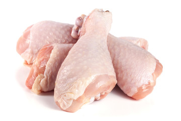 four raw chicken drumsticks isolated on white background