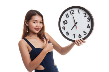 Young Asian woman thumbs up with a clock.