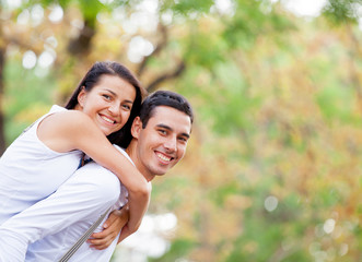 Obraz premium photo of cute couple hugging on the wonderful autumn park background