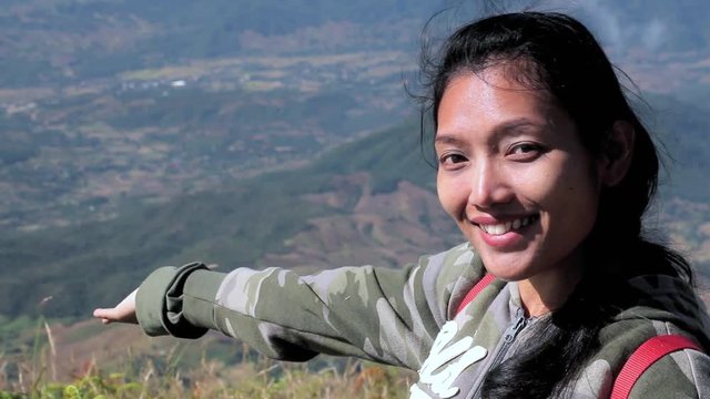 Girl shows to the valley. Tourists on the Thai mountains.Hiker on a mountain top,  the Kew Mae Pan Nature Trail in Doi Inthanon National Park, Chiang Mai province, Thailand