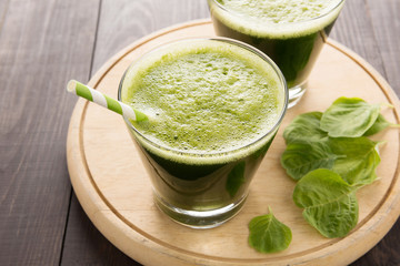 Healthy green smoothie on rustic wood background