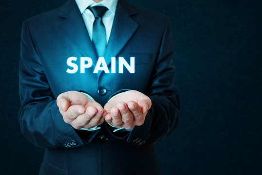 Young businessman holds a Spain word