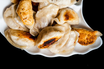 Fried dumplings on plate.