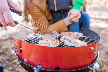 Grilling meat on charcoal grill