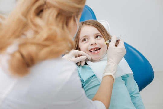 Enthusiastic adorable girl not afraid of her dentist