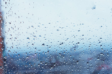 Textures of water droplets of rain flow down the windowpane. Condensation, high humidity , large...