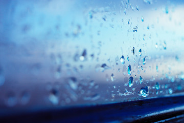 Textures of water droplets of rain flow down the windowpane. Condensation, high humidity , large...