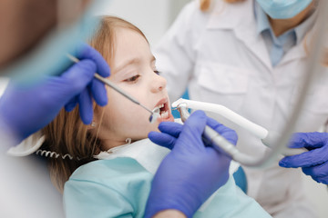 Little ginger girl having her teeth treated