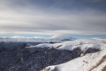 Russia. The formation and movement of clouds above the volcano Elbrus in the Caucasus Mountains in winter.