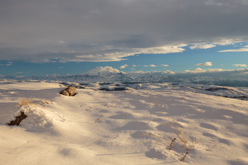 Russia. The formation and movement of clouds above the volcano Elbrus in the Caucasus Mountains in winter.