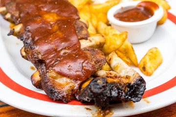 Grilled steak - Grilled meat ribs on the plate with hot sauce