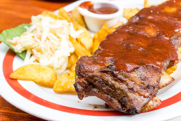 Grilled steak - Grilled meat ribs on the plate with hot sauce