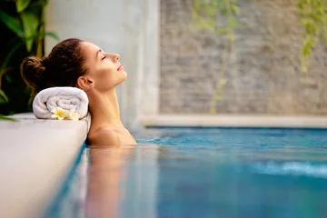 Foto op Canvas Beauty and body care. Sensual young woman relaxing in outdoor spa swimming pool. © luengo_ua