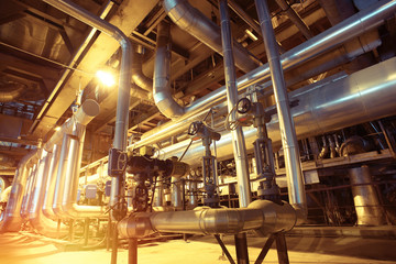 Equipment, cables and piping as found inside of a modern industrial power plant