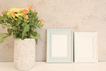 White Frame Mock Up. Rustic vase with roses. White background, empty place.  Vintage tinted