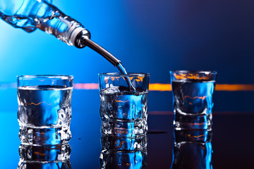 vodka in bar on a black  background - obrazy, fototapety, plakaty