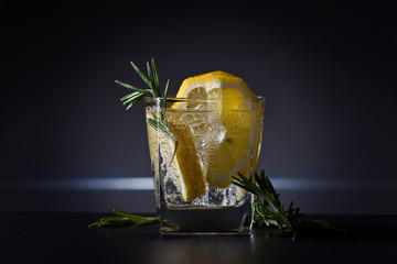 Cocktail with gin , tonic, lemon and ice.