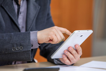 A businessman is checking emails on his smart phone.