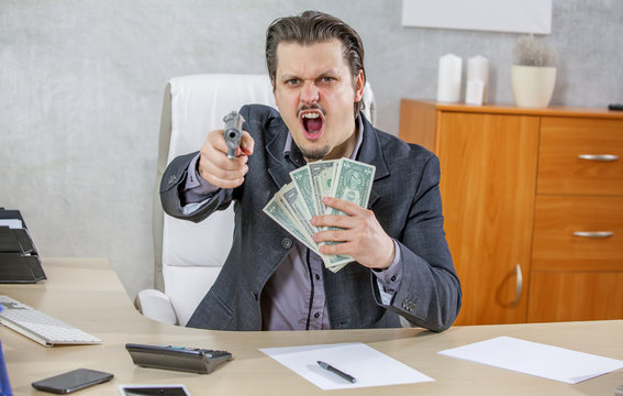 A businessman with a gun and lots of money in his hands. He gives an angry expression.
