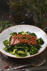 Grilled steak on a cushion of vegetables and salad