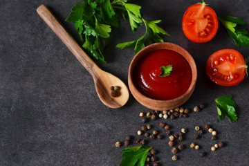 Homemade tomato sauce with spices on a black background