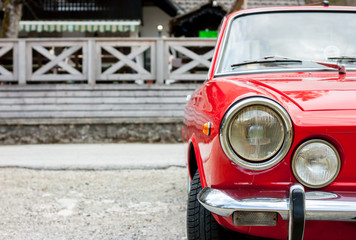 Obraz na płótnie Canvas red retro car in the countryside